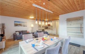 a dining room and living room with a table and chairs at Ferienhaus 41 Altefähr in Altefähr +14 photos