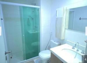 a bathroom with a shower and a toilet and a sink at Rio Stay suite Rio Centro in Rio de Janeiro