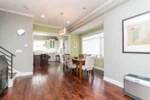 a dining room and kitchen with a table and chairs at Huge 4 Bdrm - Roof Deck - Parking - Soak Tub! in Philadelphia