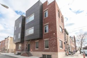 a red brick building with a black at Huge 4 Bdrm - Roof Deck - Parking - Soak Tub! in Philadelphia