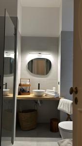 a bathroom with two sinks and a mirror at Re Nasone Rooms in Naples in Naples