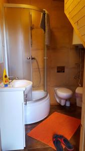 a bathroom with a shower and a tub and a sink at Domki ELDORADO in Dębki +28 photos