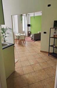 a living room with green walls and a tile floor at La Sosta Domodossola in Domodossola +3 photos
