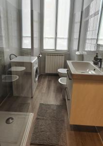 a bathroom with a washing machine and a sink at La Sosta Domodossola in Domodossola