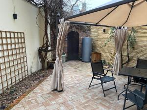 a patio with an umbrella and a table and chairs at Pini Apartments & Rooms Old Town in Kraków