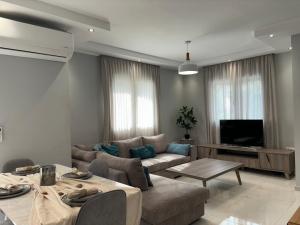 a living room with a couch and a table at Domi Luxury in Kavala