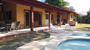 a house with a patio and a swimming pool at BEAUTIFUL HOUSE IN LAS UVAS SAN CARLOS, PANAMA WITH FRUIT TREES -SWIMMING POOL in Las Uvas