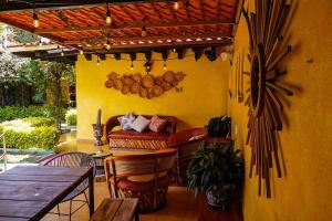 a patio with a table and a bench and a table and chairs at Casa Margarita , La fuente de la luna in Tequisquiapan