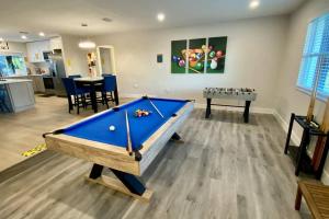 a living room with a pool table in it at Waterfront Gulf Gateway: Pool/Dock/Grill/Gameroom in Fort Myers