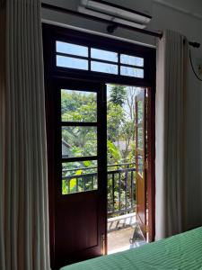 a door leading to a balcony with a window at WILSON VILLA in Hikkaduwa