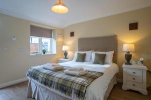 a bedroom with a bed with two towels on it at The Bedingfeld Arms in Swaffham