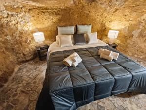 a bedroom with a large bed with two lamps at Historic Center Apartment in Agrigento