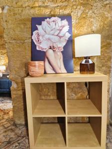 a table with a lamp and a picture on it at Historic Center Apartment in Agrigento