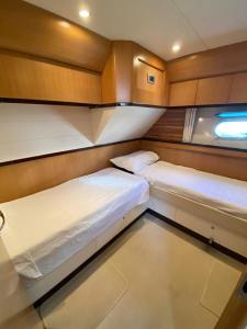 two beds in a small room on a boat at Yacht Cantieri Sarnico 60 feet in Cannigione