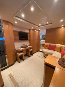 a large living room with a couch and a tv at Yacht Cantieri Sarnico 60 feet in Cannigione