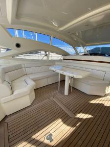 a yacht with a table and a couch on the deck at Yacht Cantieri Sarnico 60 feet in Cannigione