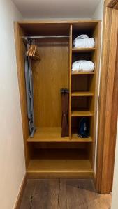 a closet with a wooden cabinet with a knife at The Saddle Room in Middleham