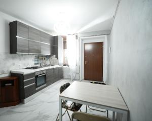 eine Küche mit einem Tisch und einer Arbeitsplatte in der Unterkunft La Casa di Chiara 