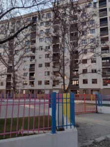 una recinzione colorata di fronte a un edificio di F&M Apartment No 18 a Skopje