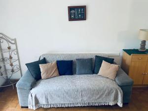 a blue couch with pillows in a living room at Les Hauts YourHosHelper in Saint-Cyr-sur-Mer