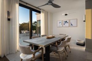 a dining room with a wooden table and chairs at Upper East Side Enclave #14 in Long Bay Hills