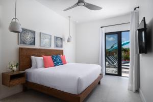 a bedroom with a bed with a ceiling fan at Upper East Side Enclave #14 in Long Bay Hills +30 photos