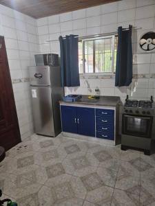 eine Küche mit einem Kühlschrank und einem Herd in der Unterkunft Casa de playa in Santa Vitória do Palmar