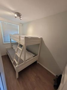 a small room with a bunk bed in the corner at Wonderful appartement with a nice view. Parking! in Sola