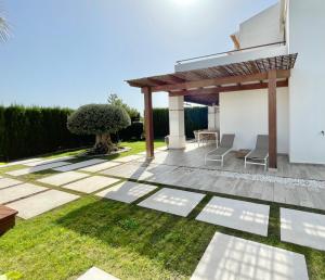 a garden with a pergola and grass at HOUSE WITH PRIVATE GARDEN in Finestrat