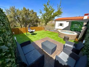 a backyard with a pool and chairs and a hammock at Cantinho do Vale - Oleiros in Oleiros