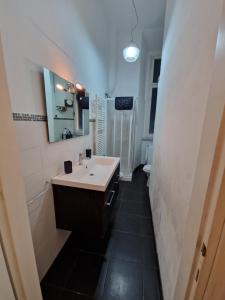 a bathroom with a sink and a mirror at Casa Francesca in Livorno
