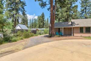 a house with a tree in the driveway at Private Cottage Near Scenic Deschutes River Woods! in Bend