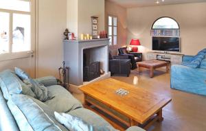 a living room with a couch and a fireplace at Le Roman Bleu in Paradou +23 photos