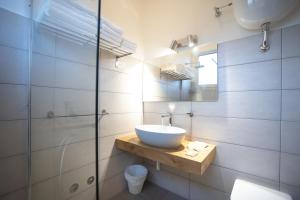 a bathroom with a sink and a glass shower at Hotel Leon D'Oro in Alfedena