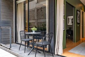 a patio with a table and chairs on a balcony at Dpto Recién Remodelado y con Patio (Lastarria) in Santiago