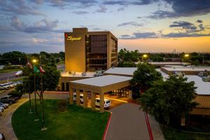 a building with a sign on it in a parking lot at MCM Elegante Hotel in Odessa