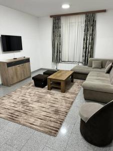 a living room with a couch and a table at Lux apartment Bijeljina in Bijeljina
