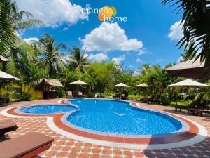 a swimming pool at a resort at Mango Home Riverside Eco - Resort in Ben Tre