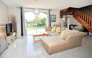 a living room with a couch and a tv at Nice Home In Eyguieres With Wifi in Eyguières