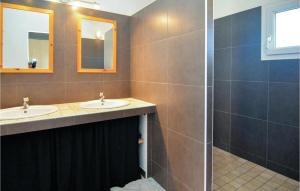 a bathroom with two sinks and a shower at Nice Home In Eyguieres With Wifi in Eyguières +40 photos