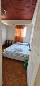 a bed in a room with a window at Hotel Sol Llanero in Yopal