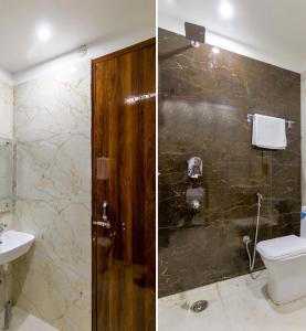 a bathroom with a shower and a toilet and a sink at Hotel Wonderland Inn Medanta in Gurgaon