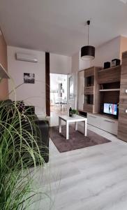 a living room with a table and a couch at Esztergom apartman in Esztergom