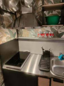 a kitchen counter with a stove and a sink at Stanza Lillina in San Benedetto del Tronto