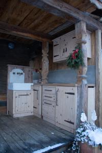 a kitchen with white cabinets in a cabin at Apartma kašča in Domžale