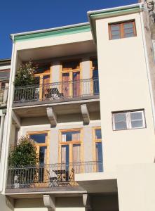 a white building with windows and balconies at Loulé Estúdios in Porto