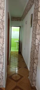 a hallway with a room with a stone wall at Artan apartment in Vlorë