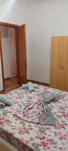 a bedroom with a large bed with flowers on it at Artan apartment in Vlorë