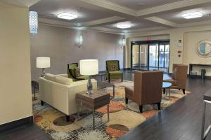 a lobby with a couch and chairs and a table at Baymont by Wyndham Bessemer in Bessemer