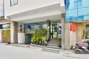 a store front of a building with stairs and plants at Hotel Gloory Suites Near Delhi Airport in New Delhi